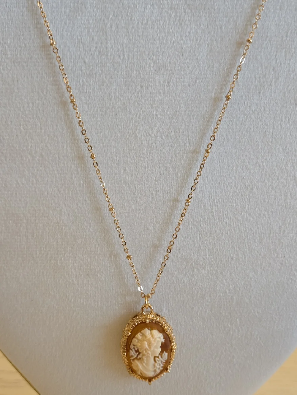Gold Raised Cameo Pendant Necklace On Intricate Diamond Cut Chain Back in Stock.